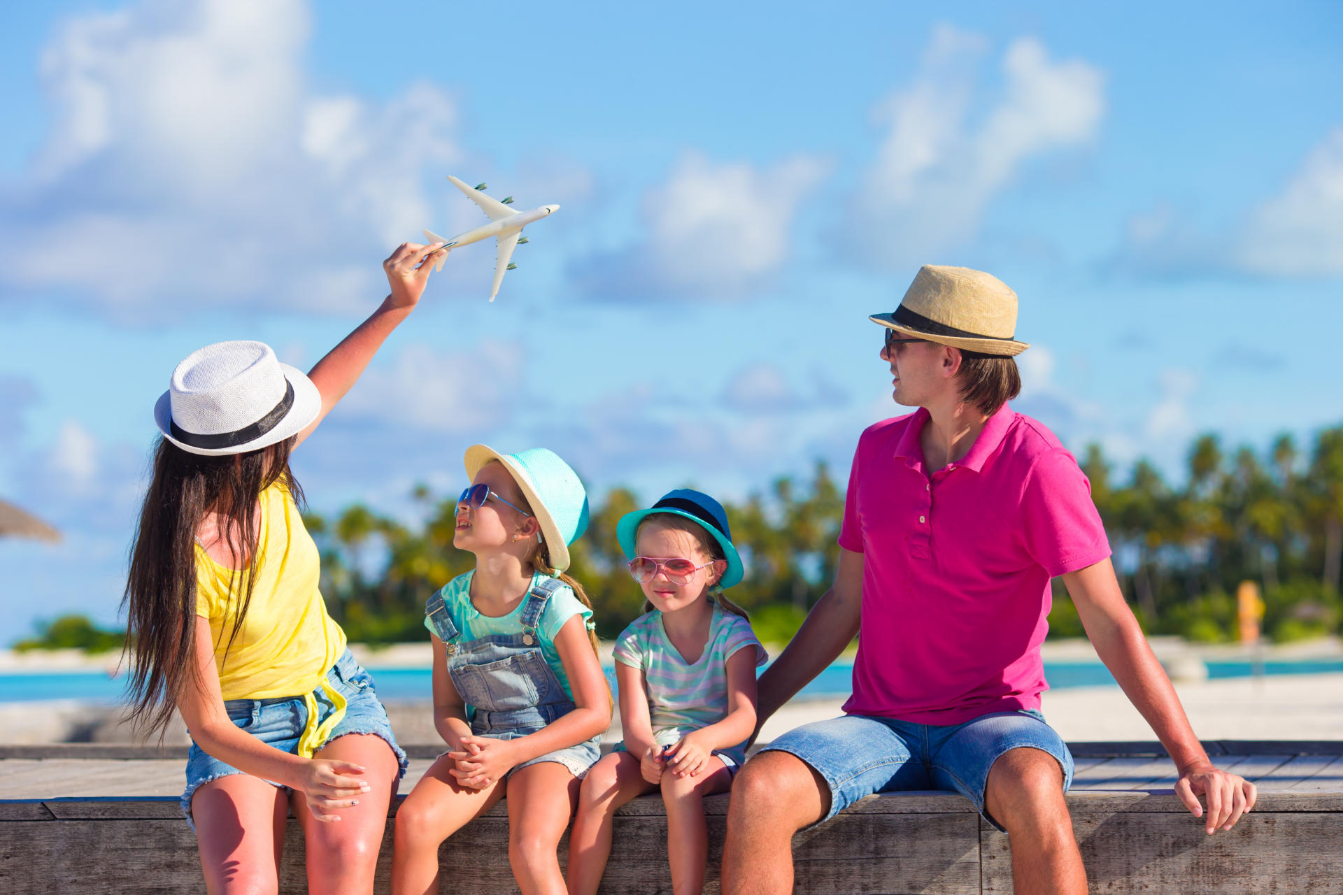 Family vacation. Airplane in woman hand.